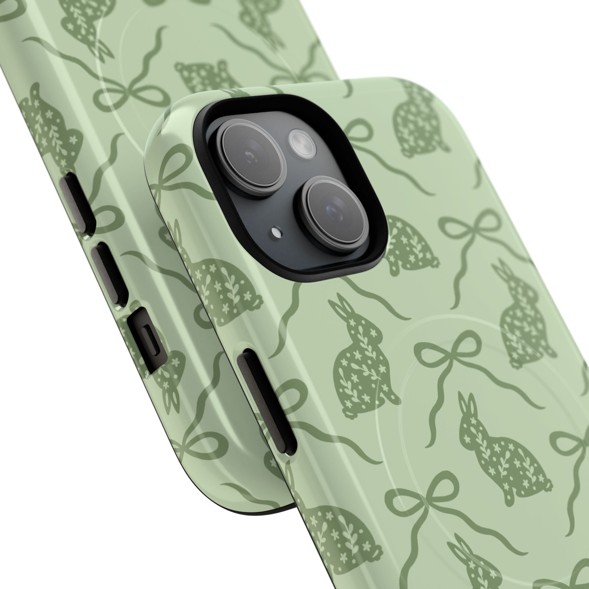 Sage green floral bunny iPhone case with MagSafe compatibility featuring dual-layer protective construction, hand-drawn rabbit and bow design on mint green background with matte or glossy finish for wireless charging